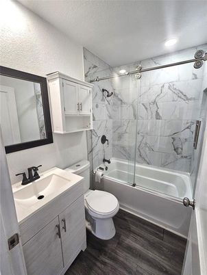 Bathroom, Glass Shower, Interior, Marble Walls, Recessed Lighting, Wood Texture Flooring