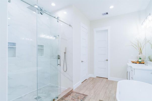 Bathroom, Free Standing Baths, Glass Shower, Interior, Marble Walls, Recessed Lighting, Wood Texture Flooring