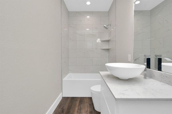 Bathroom, Free Standing Baths, Interior, Marble Walls, Recessed Lighting, Wood Texture Flooring