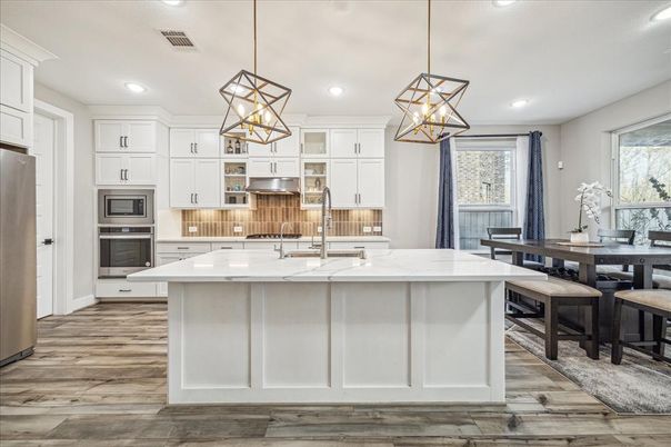 Dining room, Interior, Kitchen, Pendant Lights, Recessed Lighting, Stainless Steel Appliances, Wood Texture Flooring