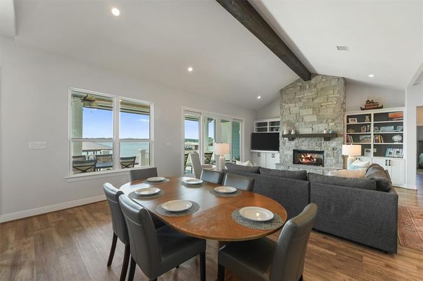 Dining room, Fireplace, Interior, Living room, Recessed Lighting, Stone Walls, Water, Wooden Beams, Wood Texture Flooring