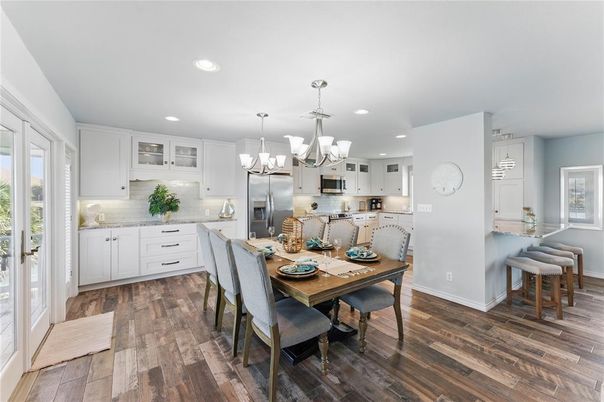 Chandelier, Dining room, Interior, Kitchen, Pendant Lights, Recessed Lighting, Stainless Steel Appliances, Wood Texture Flooring