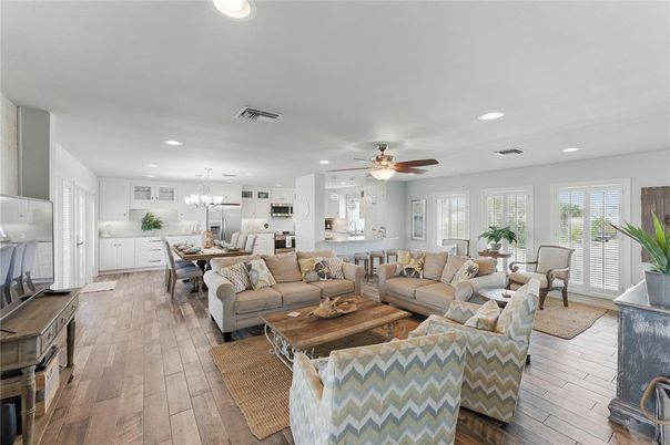 Chandelier, Dining room, Interior, Kitchen, Living room, Pendant Lights, Recessed Lighting, Stainless Steel Appliances, Wood Texture Flooring
