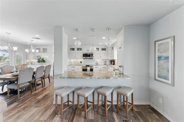 Dining room, Interior, Kitchen, Pendant Lights, Recessed Lighting, Stainless Steel Appliances, Wood Texture Flooring