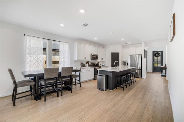 Dining room, Interior, Kitchen, Recessed Lighting, Stainless Steel Appliances, Wood Texture Flooring