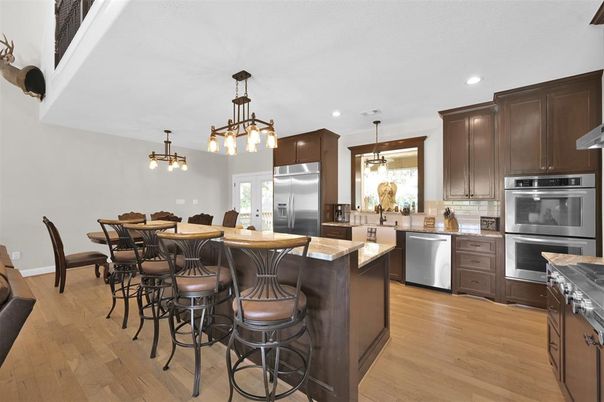 Dining room, Interior, Kitchen, Pendant Lights, Recessed Lighting, Stainless Steel Appliances, Wood Texture Flooring