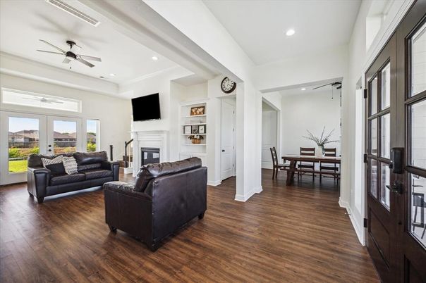 Dining room, Fireplace, Interior, Living room, Recessed Lighting, Wood Texture Flooring