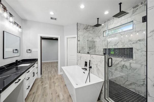 Bathroom, Dual Sink Vanities, Free Standing Baths, Glass Shower, Interior, Marble Walls, Recessed Lighting, Wood Texture Flooring