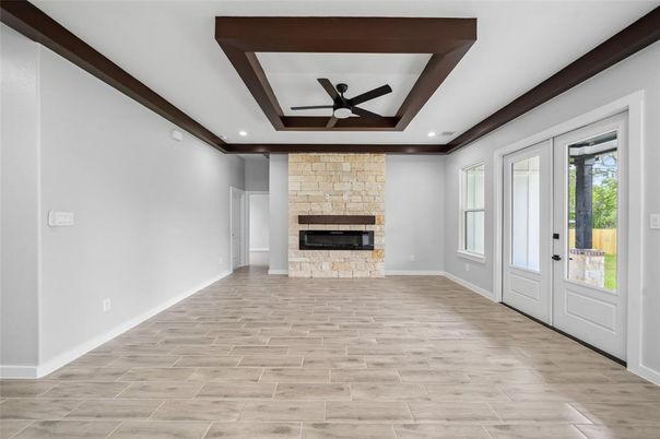 Empty room, Fireplace, Interior, Recessed Lighting, Stone Walls, Wood Texture Flooring