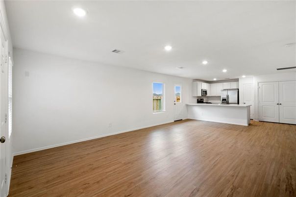 Empty room, Interior, Kitchen, Recessed Lighting, Stainless Steel Appliances, Wood Texture Flooring