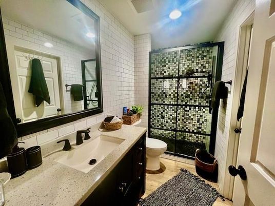 Bathroom, Glass Shower, Interior, Recessed Lighting, Stone Walls, Wood Texture Flooring