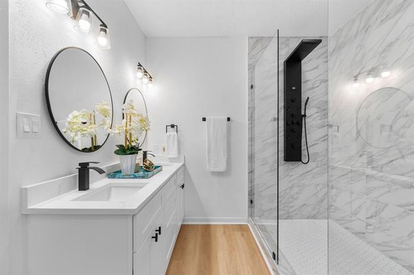 Bathroom, Dual Sink Vanities, Glass Shower, Interior, Marble Walls, Wood Texture Flooring