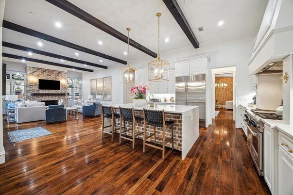 Fireplace, Interior, Kitchen, Living room, Pendant Lights, Recessed Lighting, Stainless Steel Appliances, Stone Walls, Wooden Beams, Wood Texture Flooring