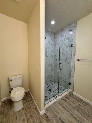 Bathroom, Glass Shower, Interior, Marble Walls, Recessed Lighting, Wood Texture Flooring