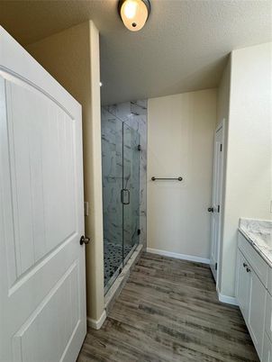 Bathroom, Glass Shower, Interior, Marble Walls, Wood Texture Flooring