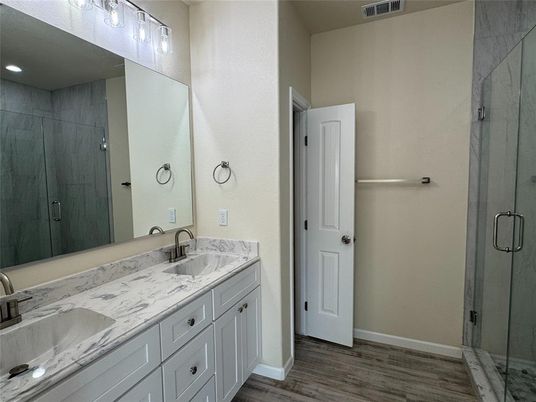Bathroom, Dual Sink Vanities, Glass Shower, Interior, Recessed Lighting, Wood Texture Flooring