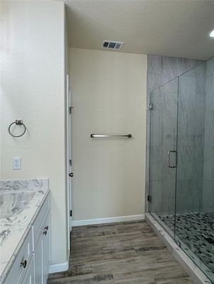 Bathroom, Glass Shower, Interior, Marble Walls, Recessed Lighting, Wood Texture Flooring