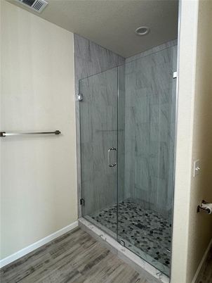 Bathroom, Glass Shower, Interior, Marble Walls, Recessed Lighting, Wood Texture Flooring