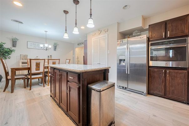 Chandelier, Dining room, Interior, Kitchen, Pendant Lights, Recessed Lighting, Stainless Steel Appliances, Wood Texture Flooring