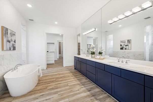 Bathroom, Dual Sink Vanities, Free Standing Baths, Interior, Marble Walls, Recessed Lighting, Wood Texture Flooring