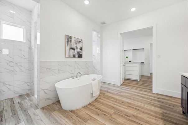 Bathroom, Free Standing Baths, Interior, Marble Walls, Recessed Lighting, Wood Texture Flooring
