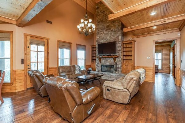 Chandelier, Fireplace, Interior, Living room, Recessed Lighting, Stone Walls, Wooden Beams, Wooden Ceilings, Wood Texture Flooring