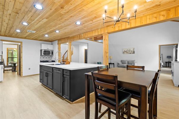 Chandelier, Dining room, Interior, Kitchen, Recessed Lighting, Stainless Steel Appliances, Wooden Ceilings, Wood Texture Flooring