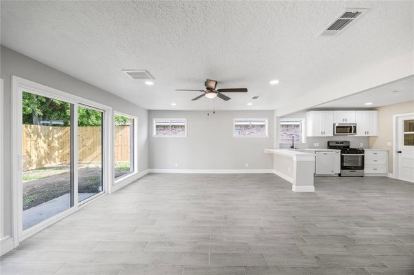 Empty room, Interior, Kitchen, Recessed Lighting, Stainless Steel Appliances, Wood Texture Flooring