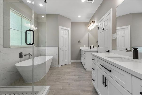Bathroom, Dual Sink Vanities, Free Standing Baths, Glass Shower, Interior, Marble Walls, Recessed Lighting, Wood Texture Flooring