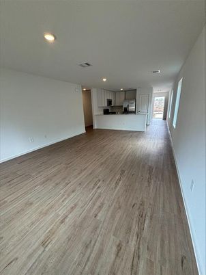 Empty room, Interior, Kitchen, Recessed Lighting, Stainless Steel Appliances, Wood Texture Flooring
