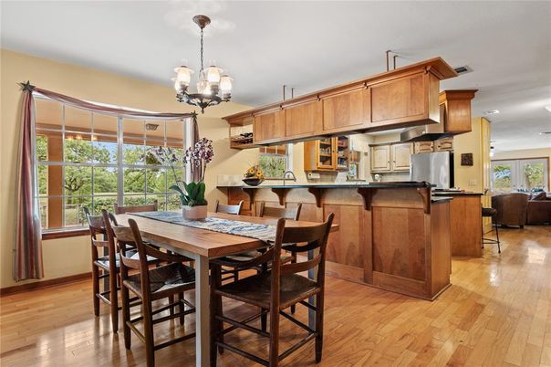 Chandelier, Dining room, Interior, Kitchen, Living room, Recessed Lighting, Stainless Steel Appliances, Wood Texture Flooring
