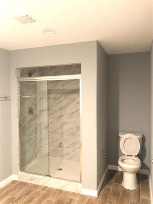 Bathroom, Glass Shower, Interior, Marble Walls, Recessed Lighting, Wood Texture Flooring