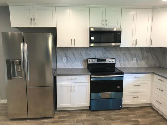 Interior, Kitchen, Marble Walls, Stainless Steel Appliances, Wood Texture Flooring