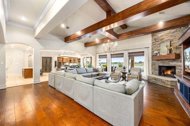 Chandelier, Fireplace, Interior, Living room, Recessed Lighting, Stone Walls, Wooden Beams, Wood Texture Flooring