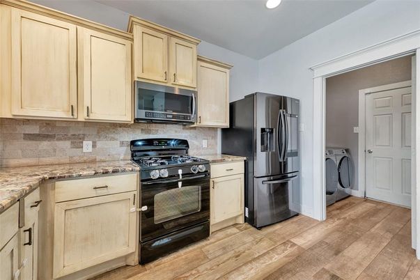 Interior, Kitchen, Recessed Lighting, Washer, Wood Texture Flooring