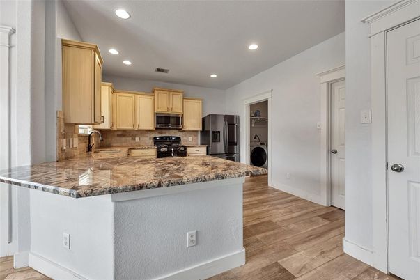 Interior, Kitchen, Recessed Lighting, Washer, Wood Texture Flooring