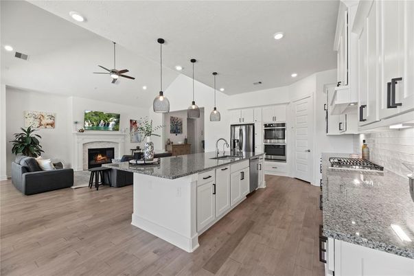 Fireplace, Interior, Kitchen, Living room, Pendant Lights, Recessed Lighting, Stainless Steel Appliances, Wood Texture Flooring