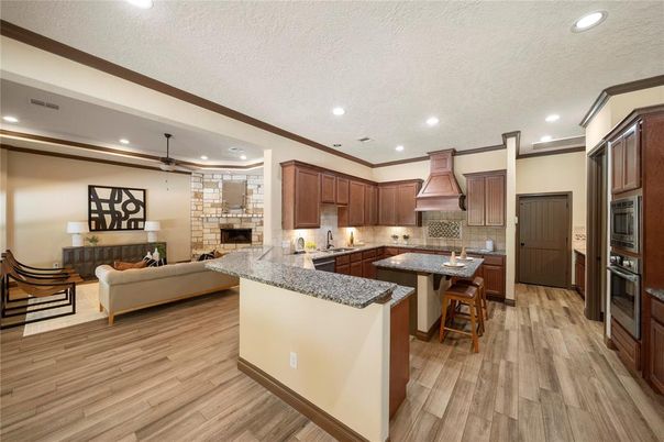 Fireplace, Interior, Kitchen, Living room, Pendant Lights, Recessed Lighting, Stainless Steel Appliances, Wood Texture Flooring
