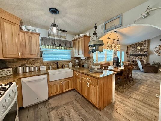 Chandelier, Dining room, Fireplace, Interior, Kitchen, Pendant Lights, Stone Walls, Wood Texture Flooring