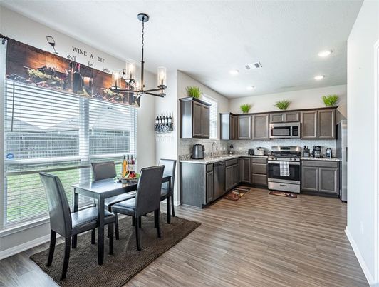 Dining room, Interior, Kitchen, Pendant Lights, Recessed Lighting, Stainless Steel Appliances, Wood Texture Flooring