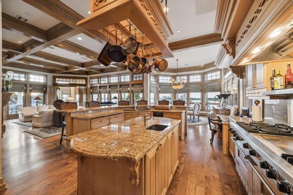 Chandelier, Dining room, Interior, Kitchen, Living room, Pendant Lights, Recessed Lighting, Stainless Steel Appliances, Wooden Beams, Wood Texture Flooring
