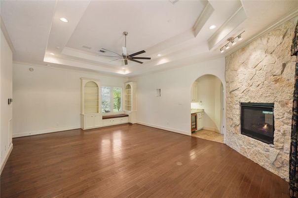 Empty room, Fireplace, Interior, Recessed Lighting, Stone Walls, Wood Texture Flooring