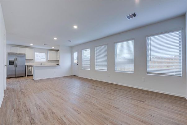 Empty room, Interior, Kitchen, Recessed Lighting, Stainless Steel Appliances, Wood Texture Flooring