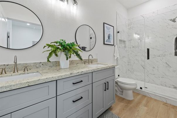 Bathroom, Dual Sink Vanities, Glass Shower, Interior, Marble Walls, Wood Texture Flooring