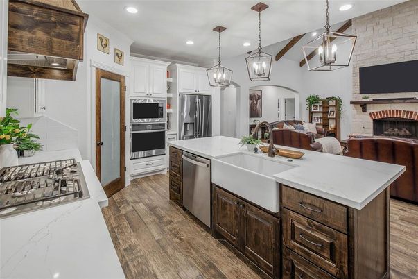Fireplace, Interior, Kitchen, Pendant Lights, Recessed Lighting, Stainless Steel Appliances, Stone Walls, Wood Texture Flooring