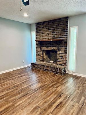 Empty room, Fireplace, Interior, Recessed Lighting, Stone Walls, Wood Texture Flooring