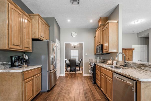 Chandelier, Dining room, Interior, Kitchen, Recessed Lighting, Stainless Steel Appliances, Wood Texture Flooring