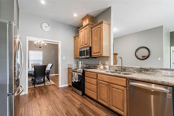 Chandelier, Dining room, Interior, Kitchen, Recessed Lighting, Stainless Steel Appliances, Wood Texture Flooring
