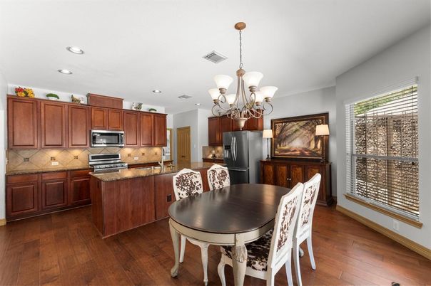 Chandelier, Dining room, Interior, Kitchen, Recessed Lighting, Stainless Steel Appliances, Wood Texture Flooring