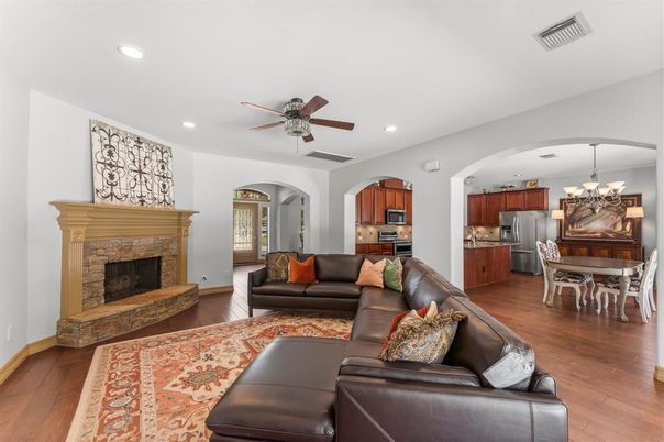 Chandelier, Dining room, Fireplace, Interior, Kitchen, Living room, Recessed Lighting, Stainless Steel Appliances, Wood Texture Flooring
